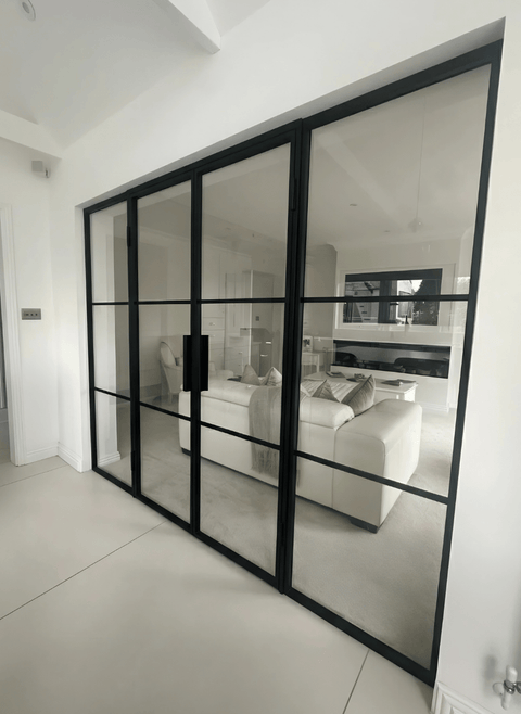 Steel double doors with fixed side screens, designed for larger openings to maximise natural light and create a seamless connection between spaces.