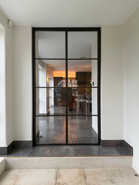 Bespoke steel double doors finished in Manor House Bronze with slim steel sightlines and architectural glazing.