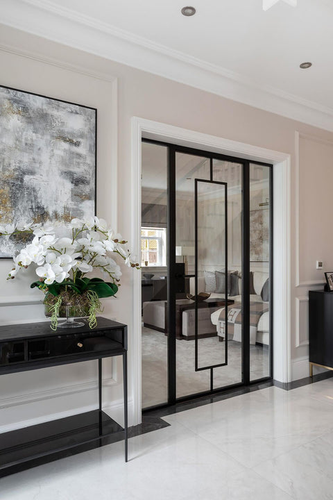Internal glass doors in a modern interior design, white flowers, and a stylish decor.