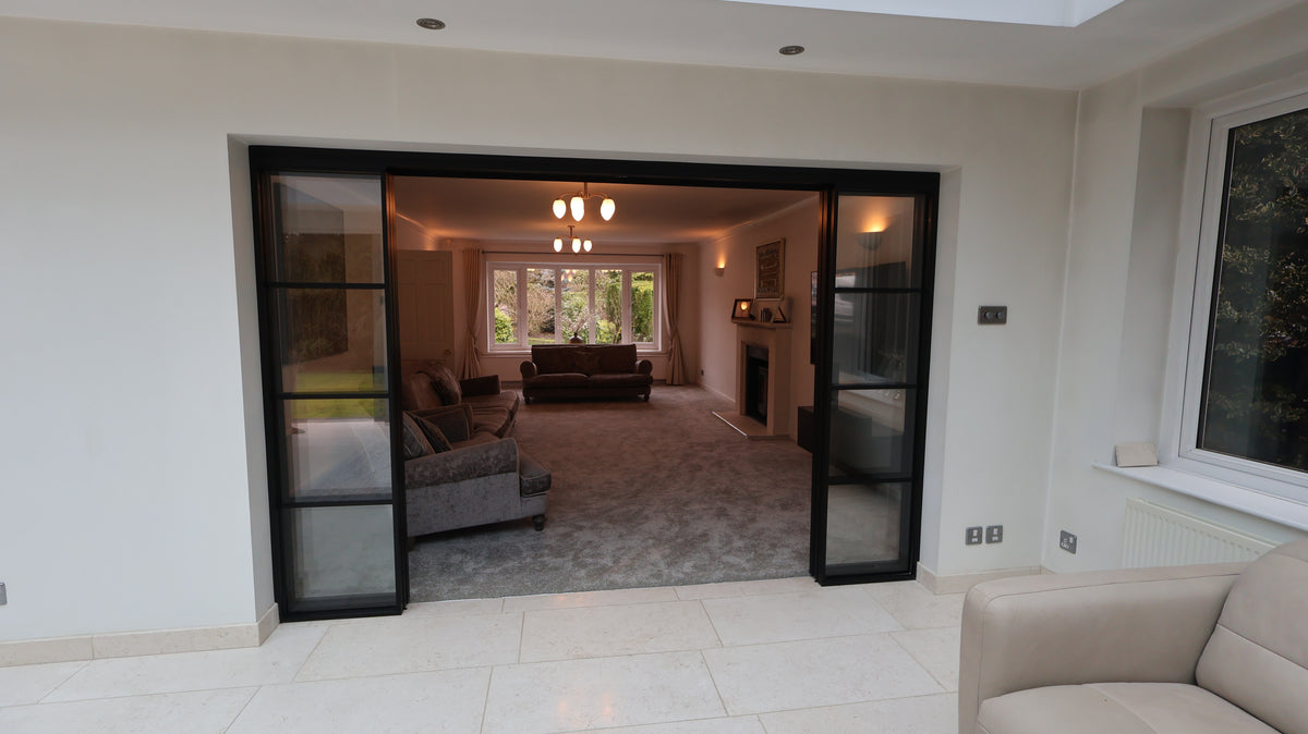 Living room with a sliding glass door leading to a conservatory