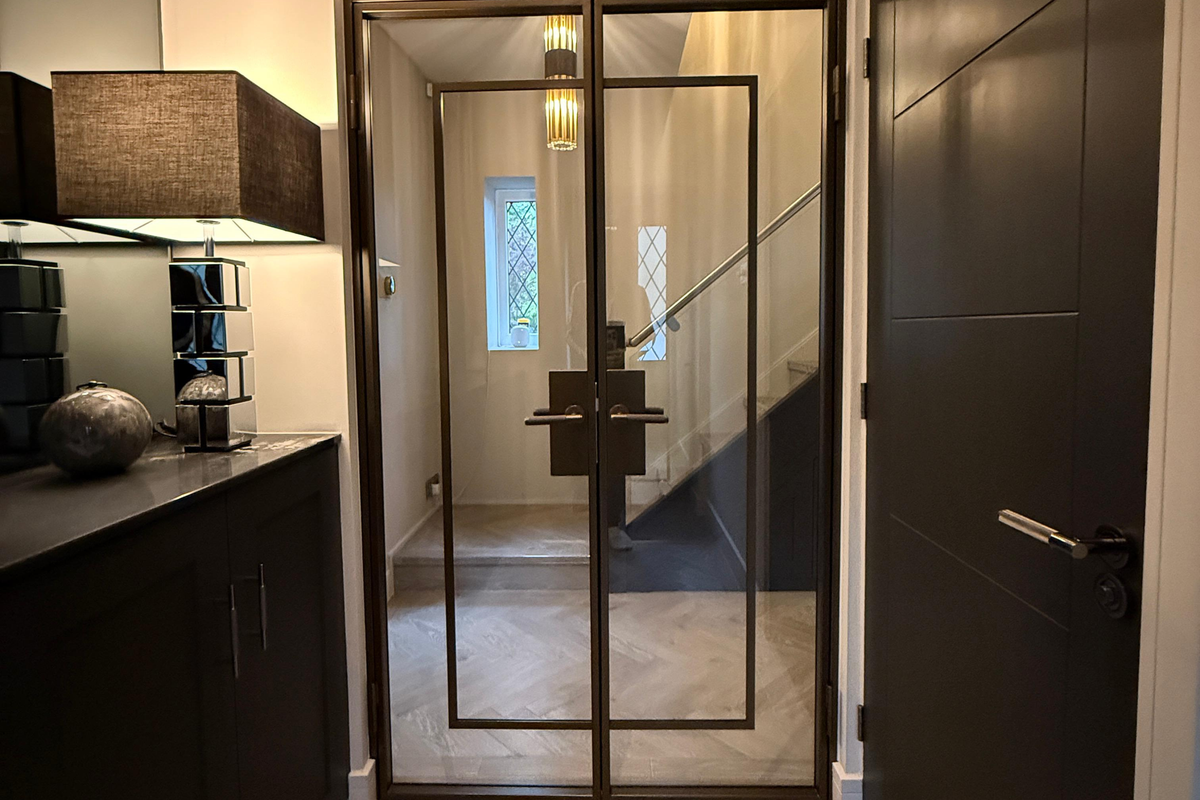 Modern interior with glass door leading to a hallway