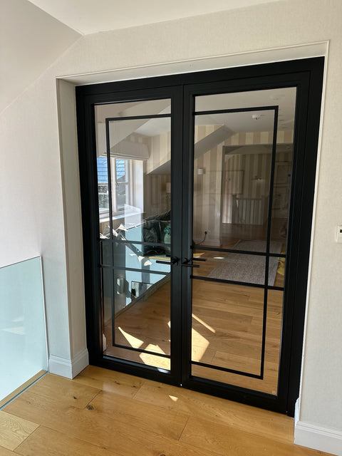 Fire Rated Crittall Doors in black steel with slim sightlines and glass panels