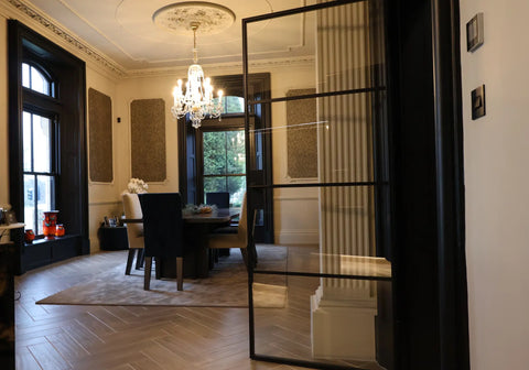 Single steel door connecting the hallway to a open plan kitchen a dinning room