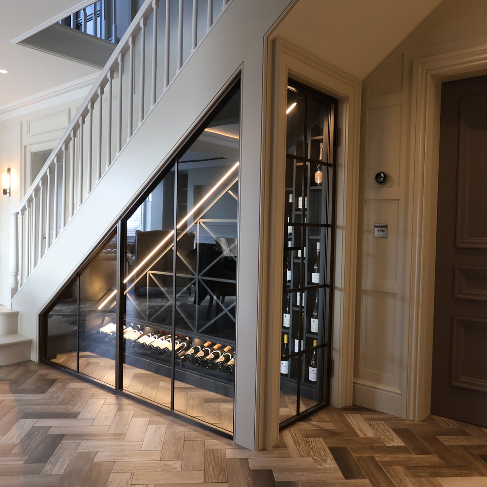 Modern interior with a staircase and glass-walled wine cellar.