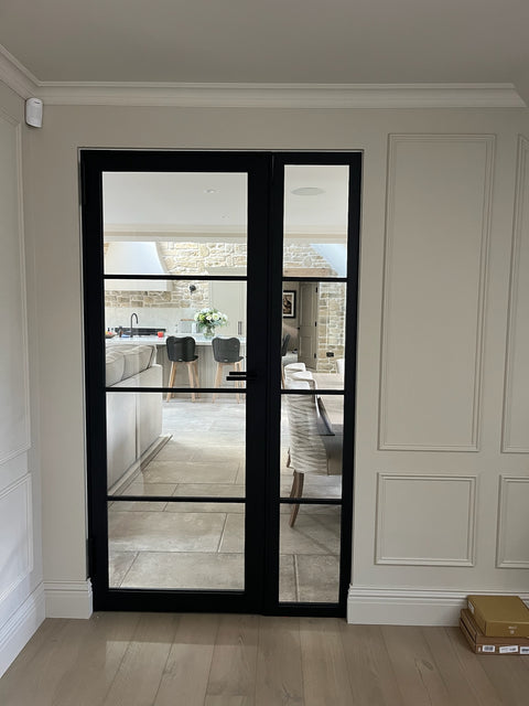 Steel fire doors with fixed screen in black steel with glass panels for internal kitchen access