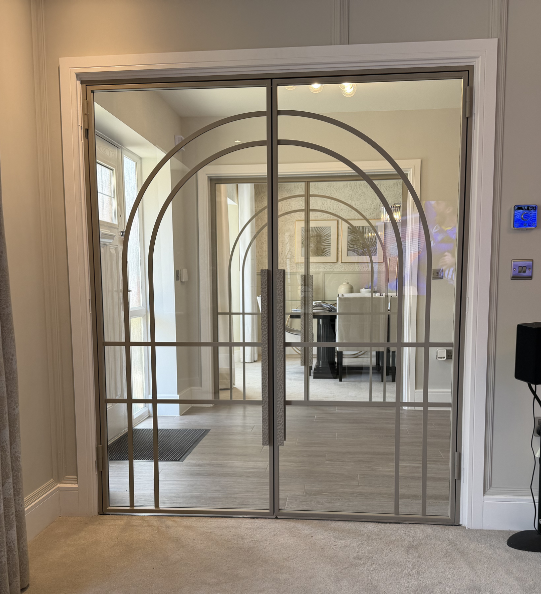Ivory sands steel door with arched bars and hammered pull handles