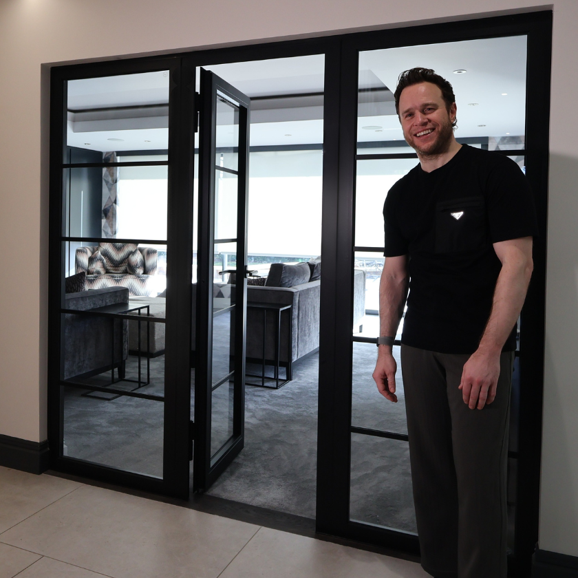 Olly Murs standing by his internal fire rated doors