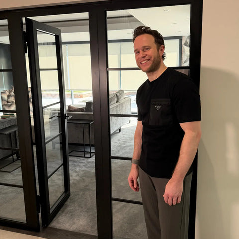Olly Murs stud next to his fire rated steel door installed by Steel Door Company