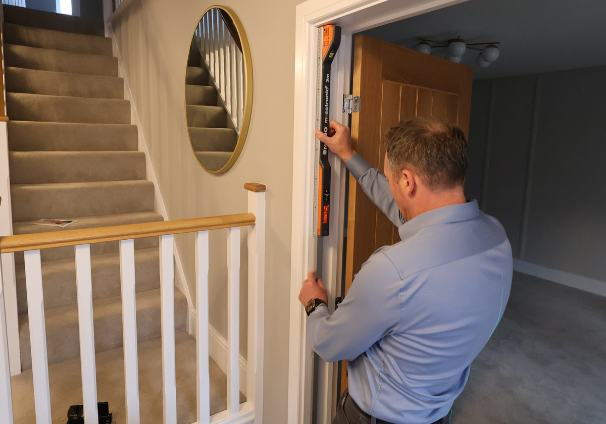 One of our Steel Door Company Surveyors getting accurate measurements of a opening