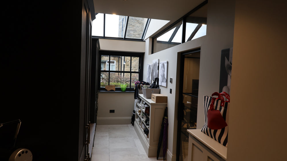 Modern interior with a single steel door and fixed top panel