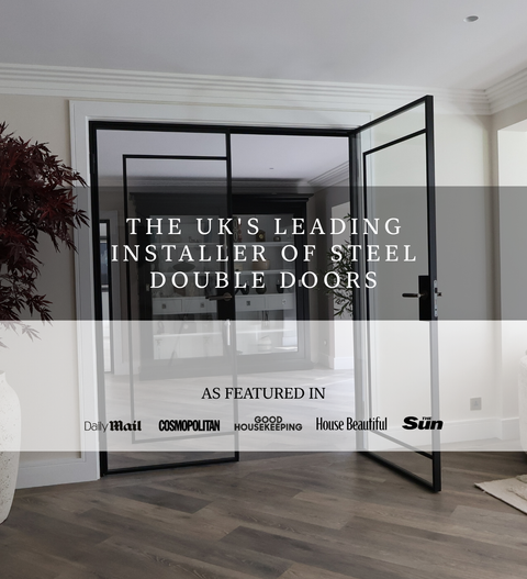 Steel double doors in a modern interior with slim black steel framing and full height glazing, opening into a bright living space, with overlay text stating the UK’s leading installer of steel double doors and featured publication logos.