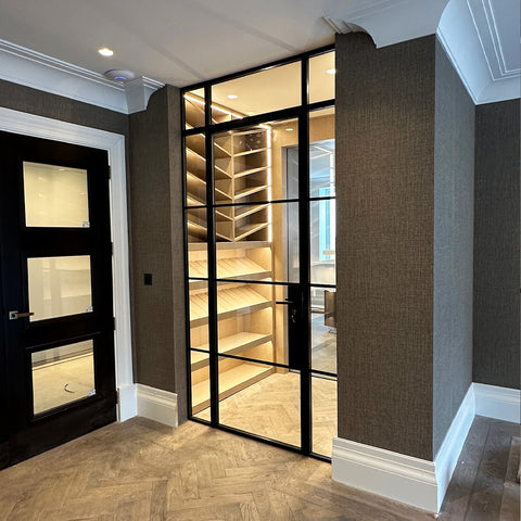 Internal single door with fixed side panels leading to a wine room 
