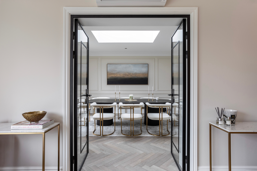 Modern interior with a glass door leading to a dining area.
