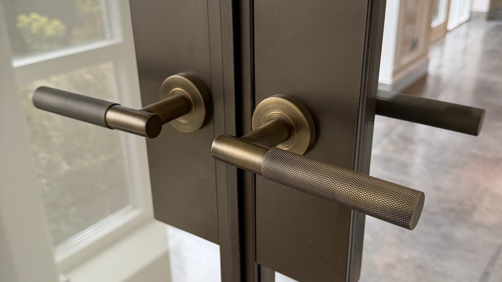 Close-up of a modern door handle on a glass door. 